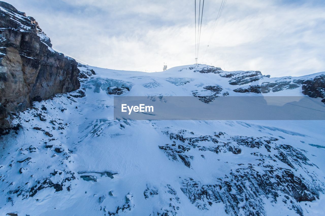 Close-up of ski lift against sky