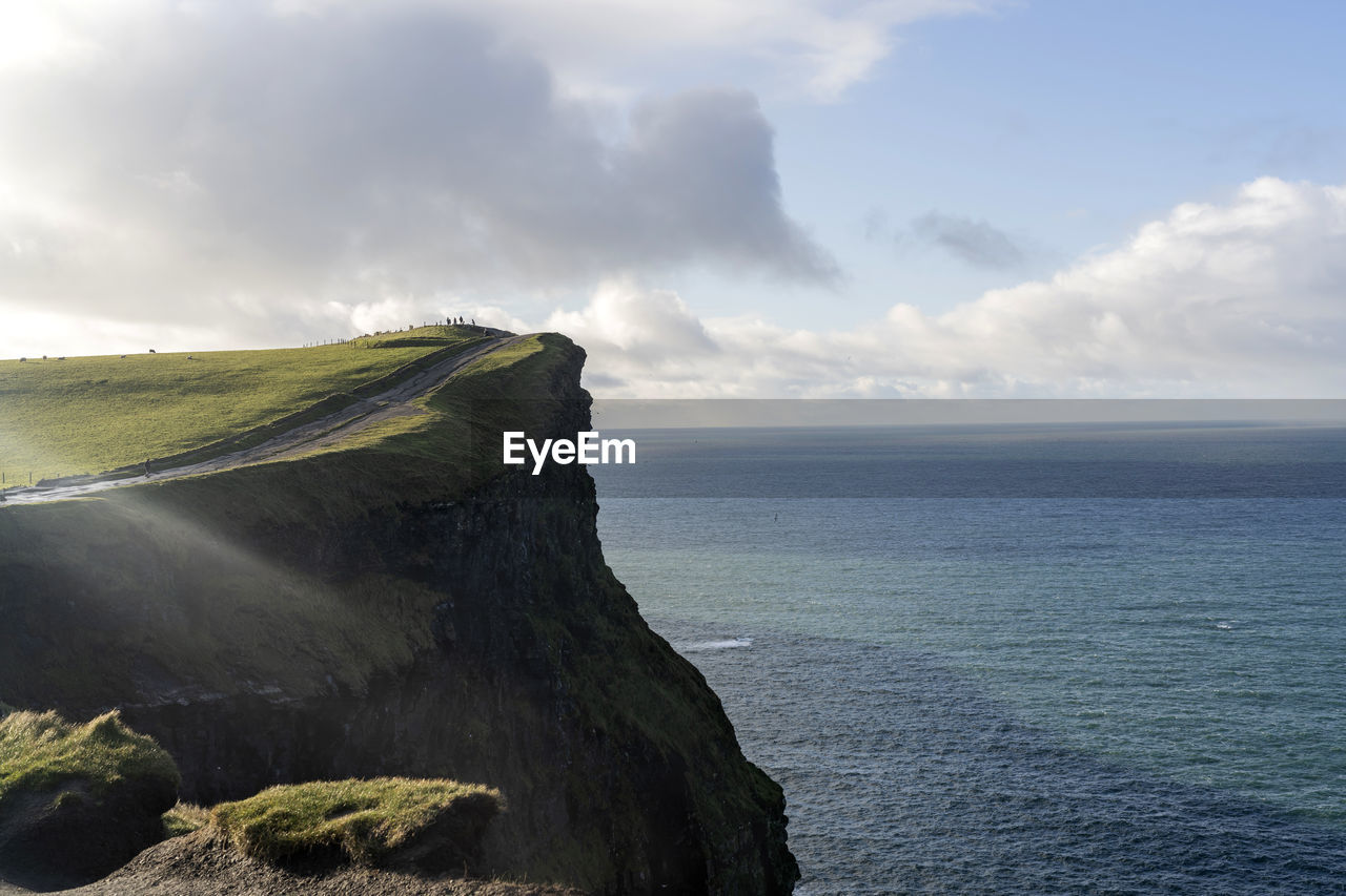 Scenic view of sea against cloudy sky