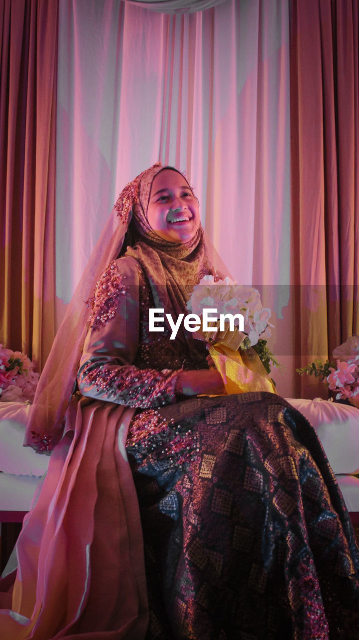 A woman wearing traditional clothing wedding for malaysian