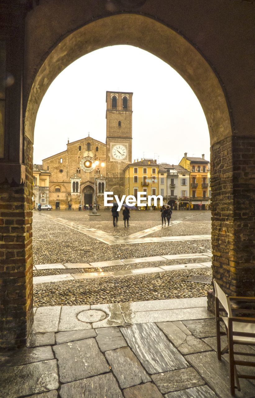 PEOPLE WALKING IN FRONT OF BUILDINGS