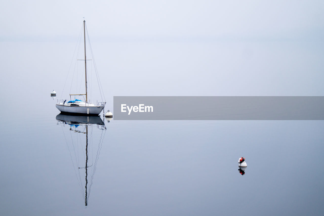 Boat on lake against sky