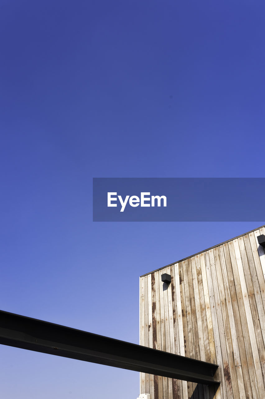 Low angle view of built structure against blue sky