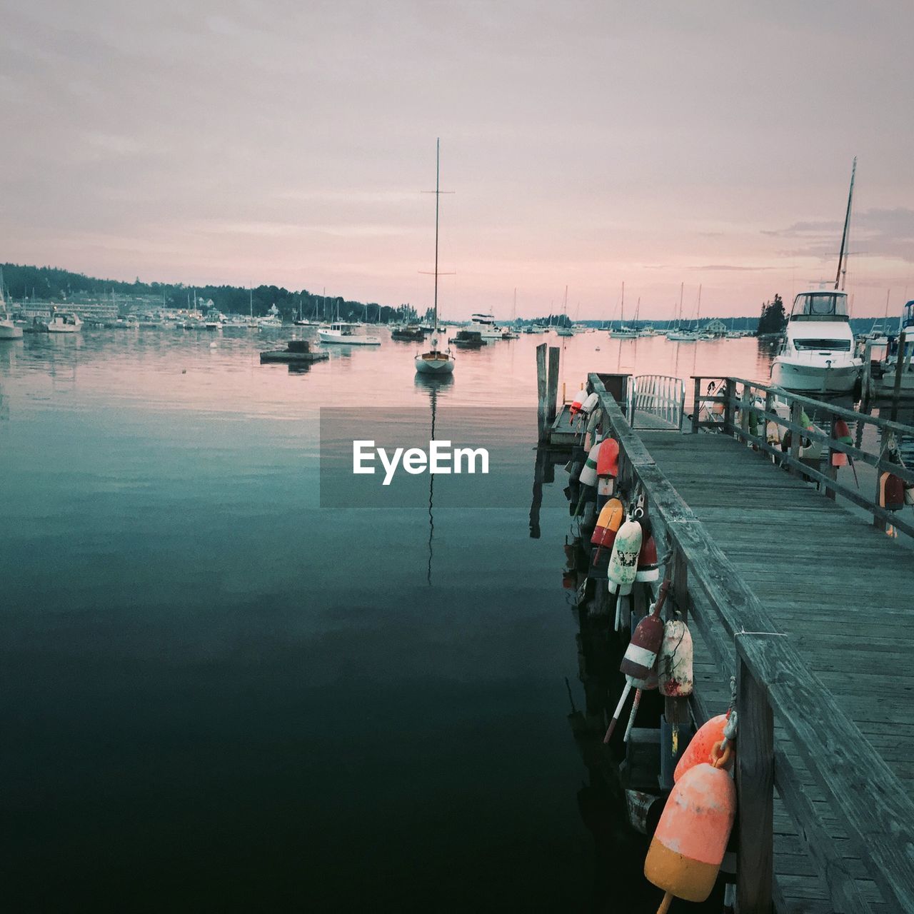 Scenic view of harbor against sky during sunset