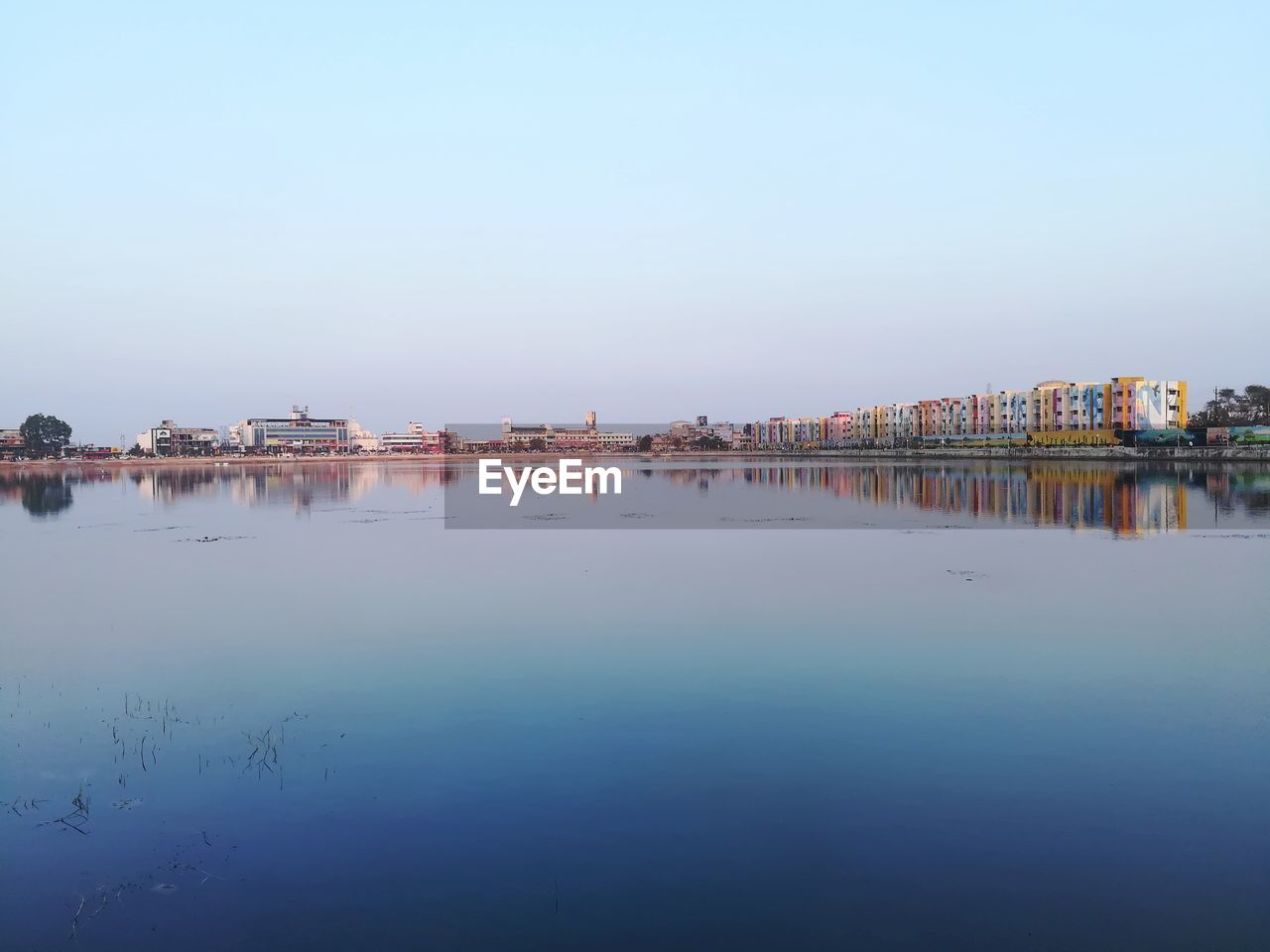 Scenic view of lake against clear blue sky