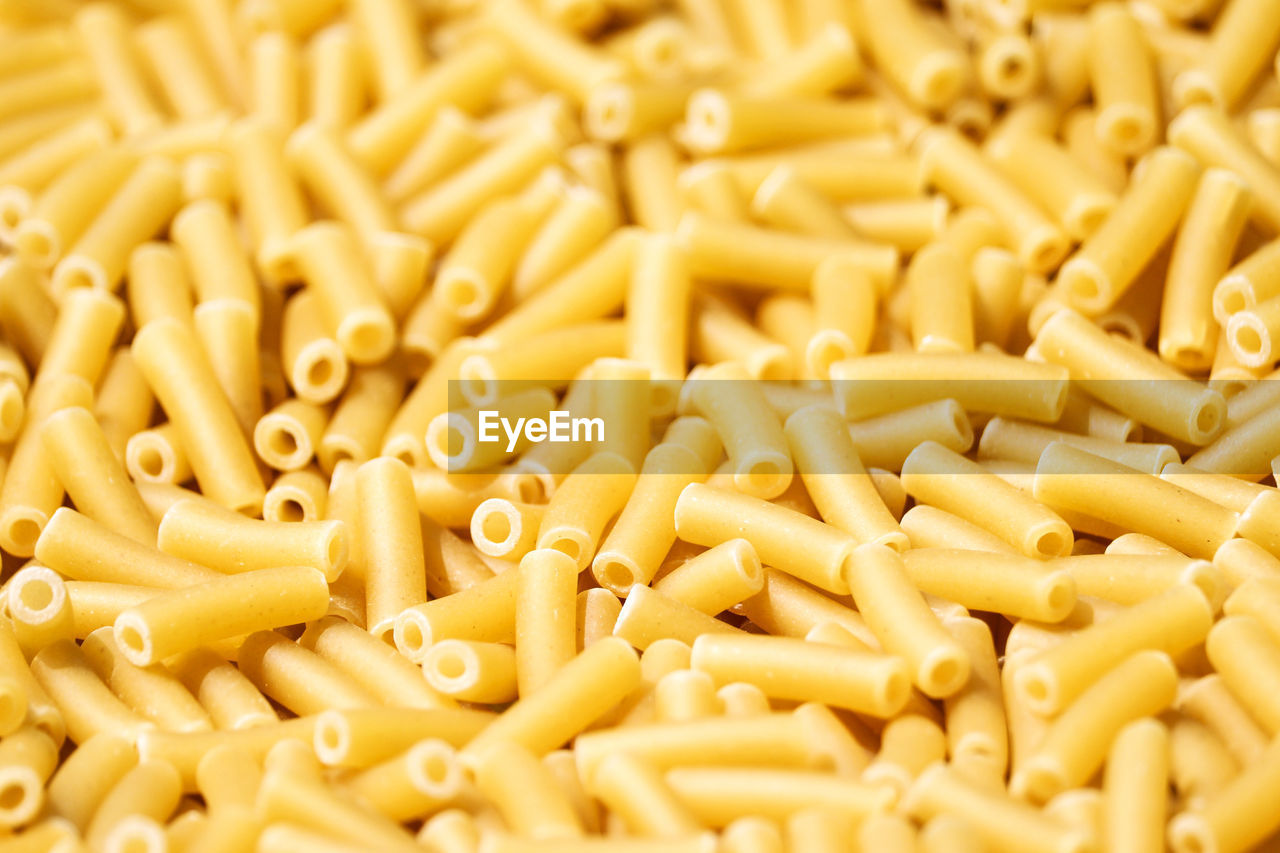 FULL FRAME SHOT OF PASTA WITH YELLOW AND VEGETABLES
