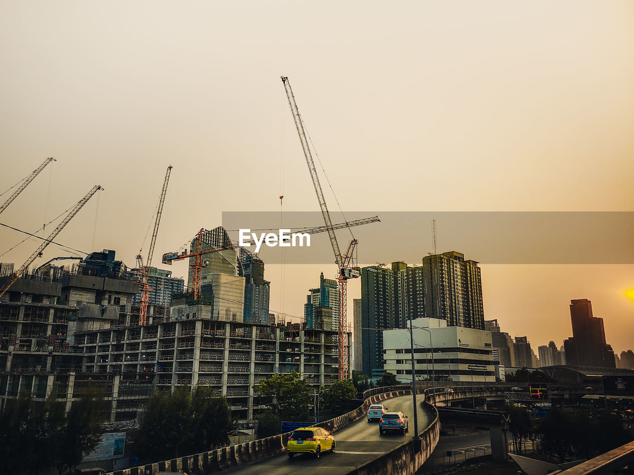 CONSTRUCTION SITE BY BUILDINGS AGAINST SKY