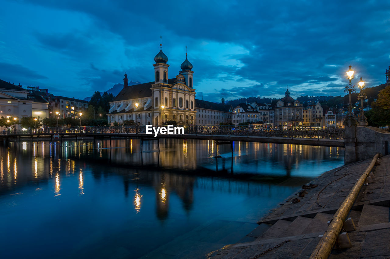 Reflection of buildings in river at night