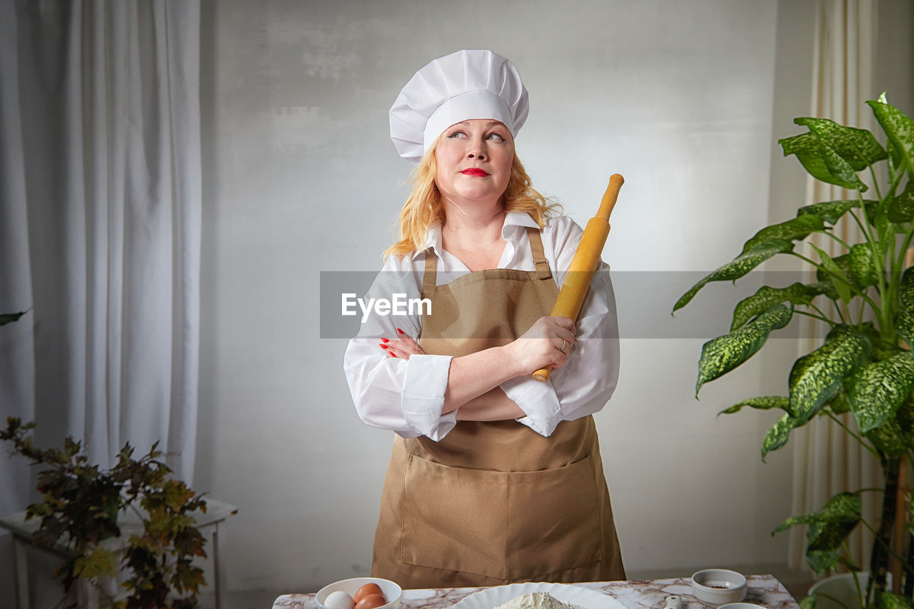 portrait of young woman sitting on table at home