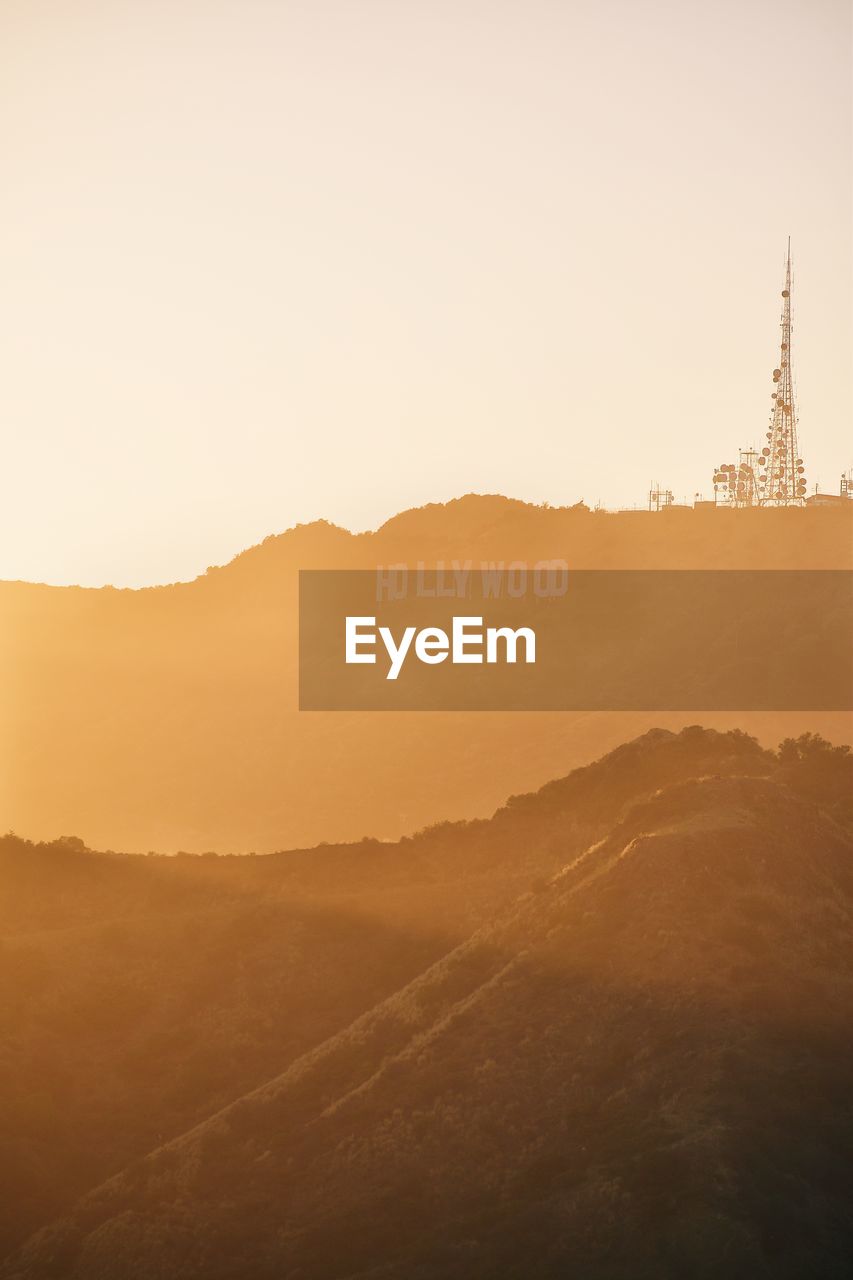 Scenic view of mountains against clear sky during sunset