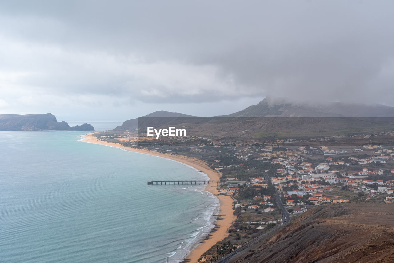 High angle view of sea and city against sky