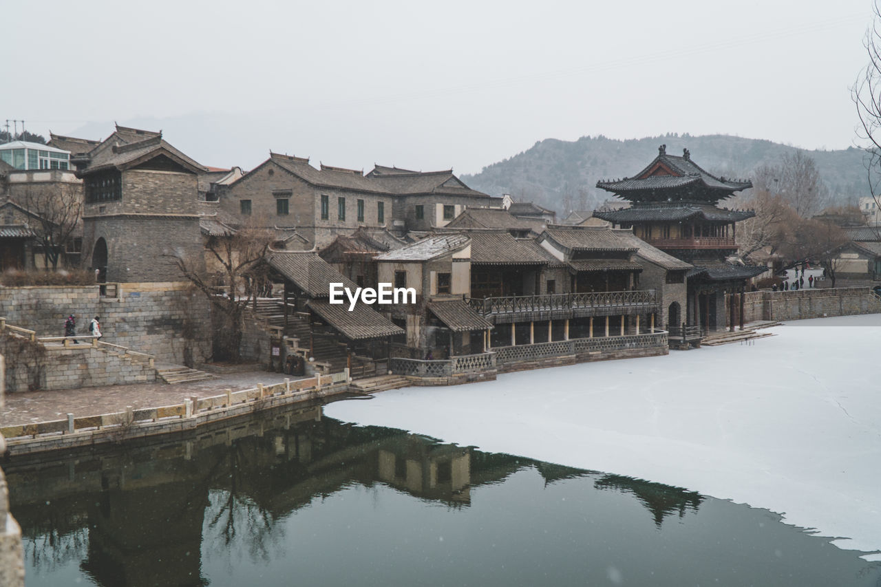 REFLECTION OF BUILDING IN LAKE