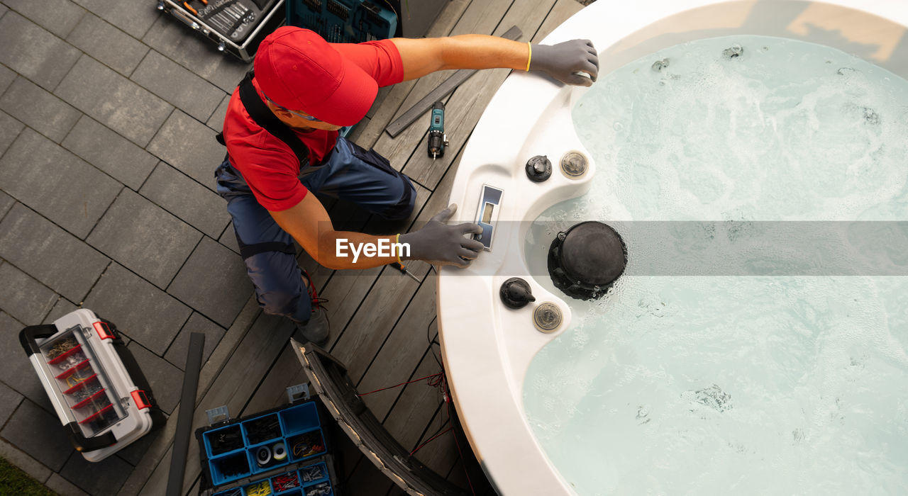 high angle view of man washing machine part