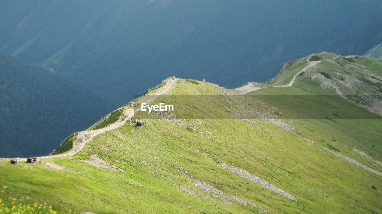 Scenic view of green mountains against sky