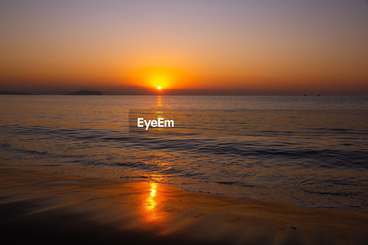 SCENIC VIEW OF SEA AGAINST ORANGE SKY