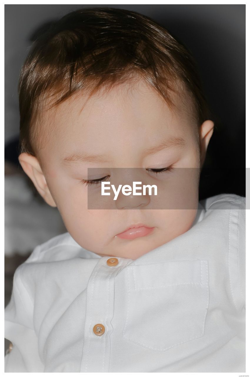 CLOSE-UP PORTRAIT OF CUTE BOY WITH BABY