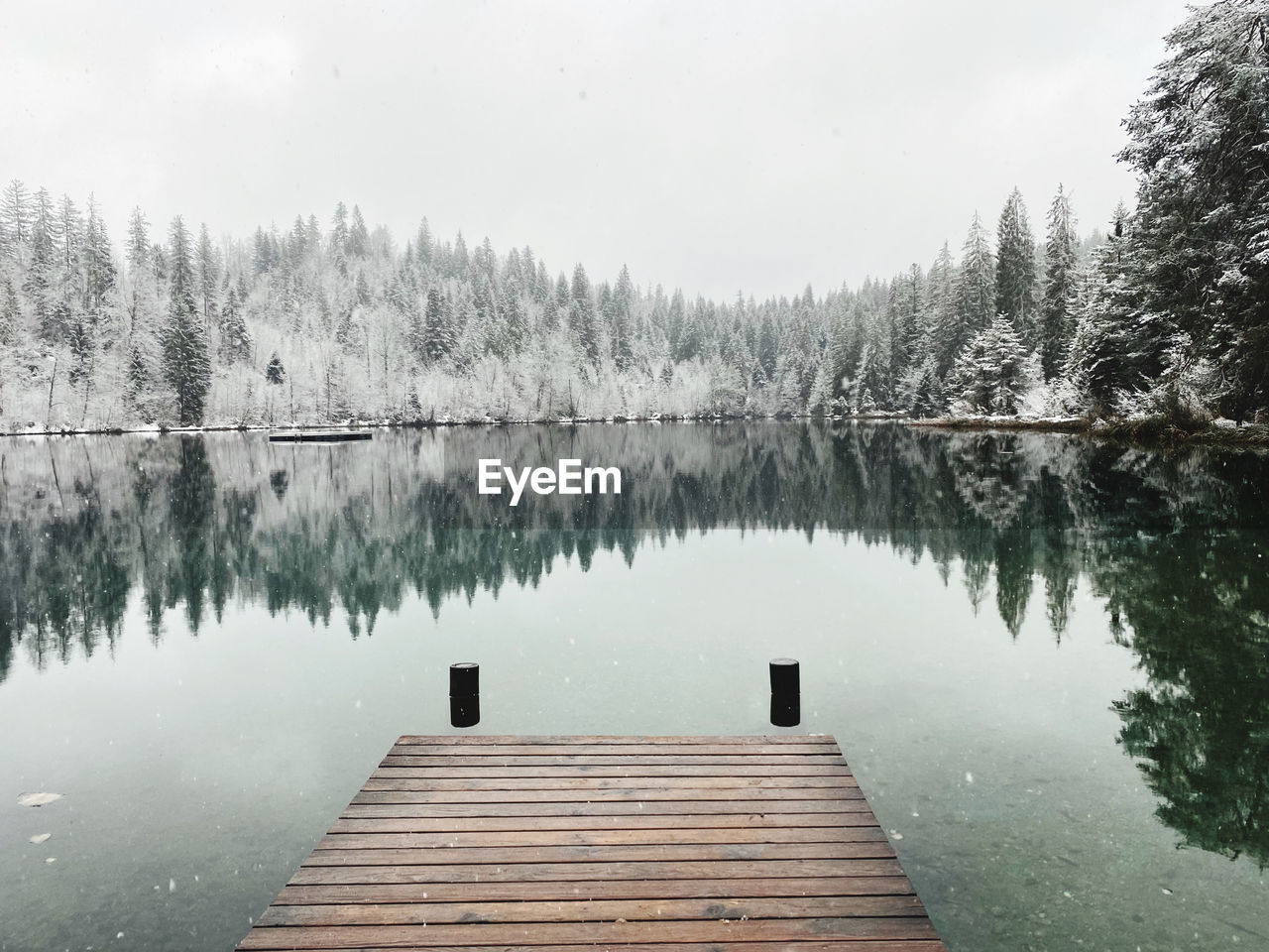 Scenic view of pier on lake against sky