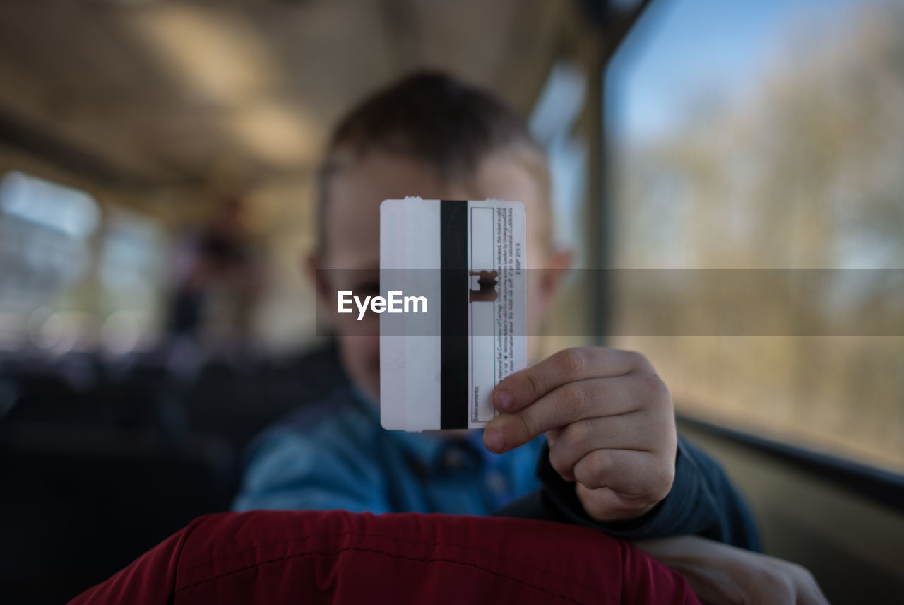 Boy holding ticket in train