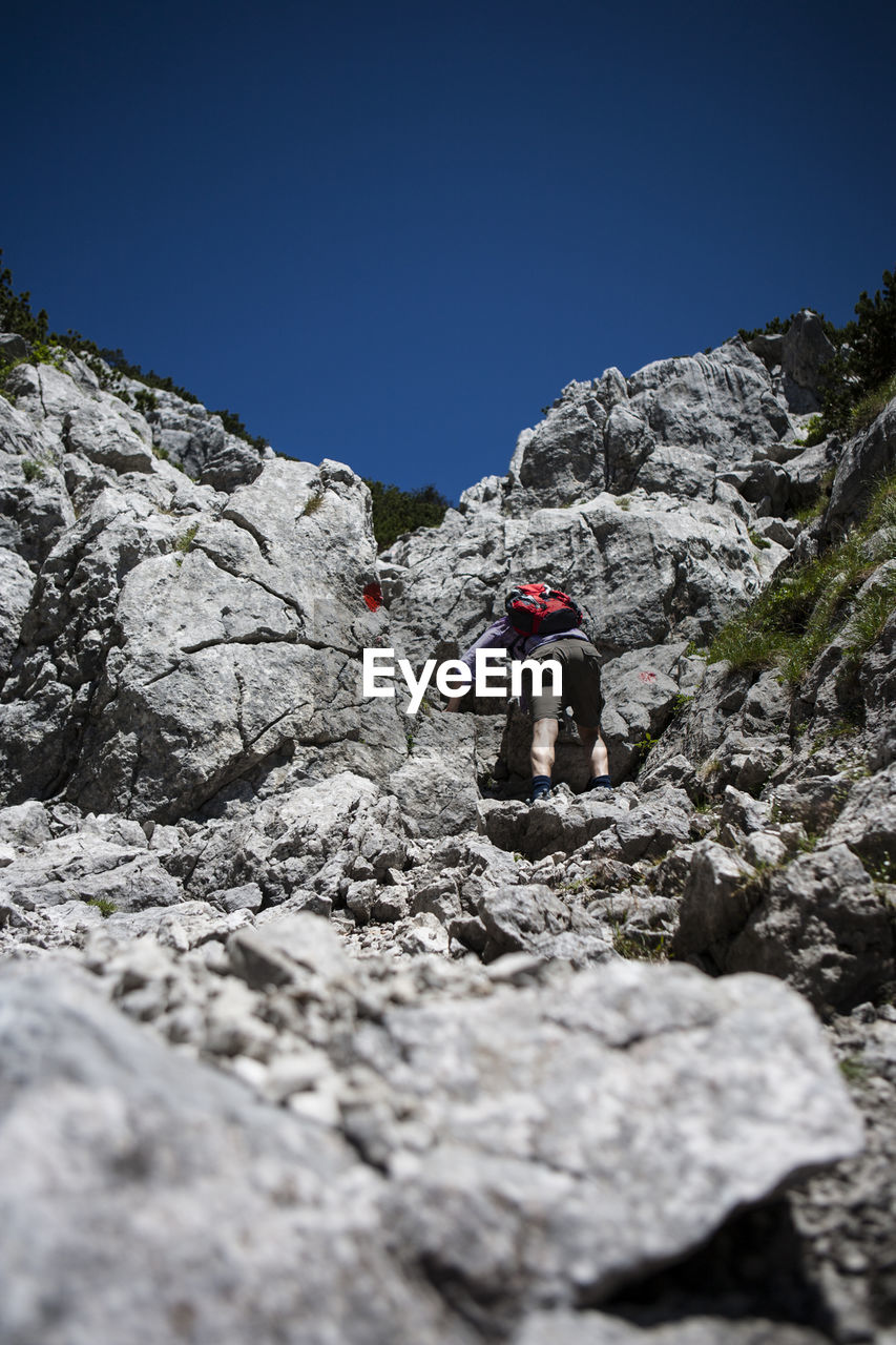 Man climbing on rocks in the summer