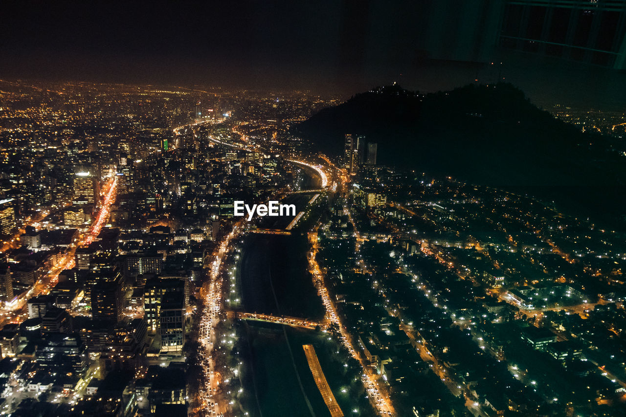 High angle view of illuminated city buildings at night