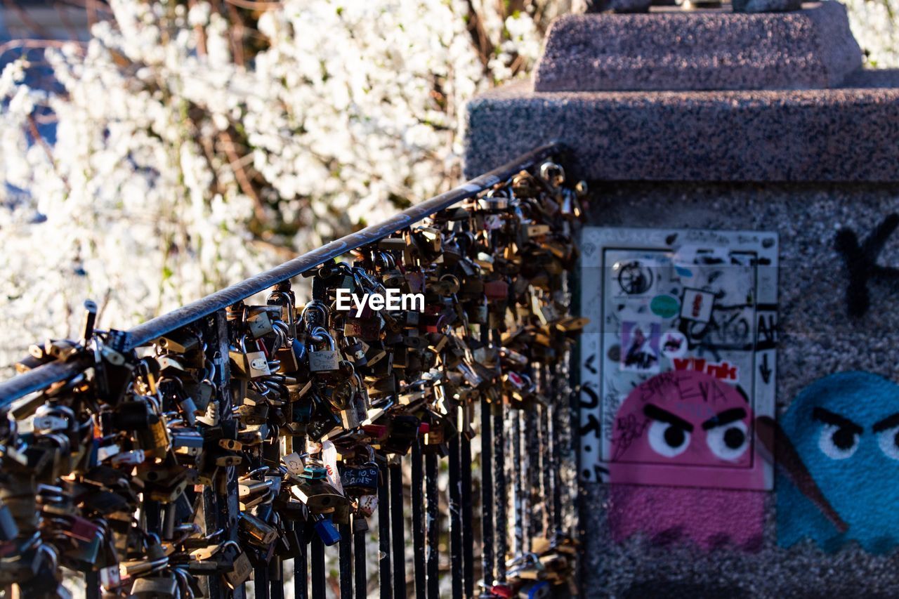 CLOSE-UP OF PADLOCKS ON METAL STRUCTURE