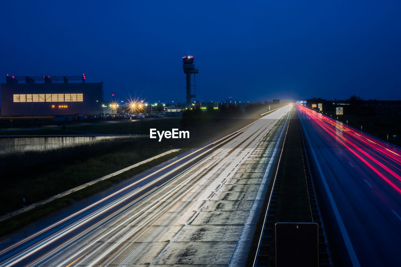 LIGHT TRAILS ON RAILROAD TRACKS AT NIGHT