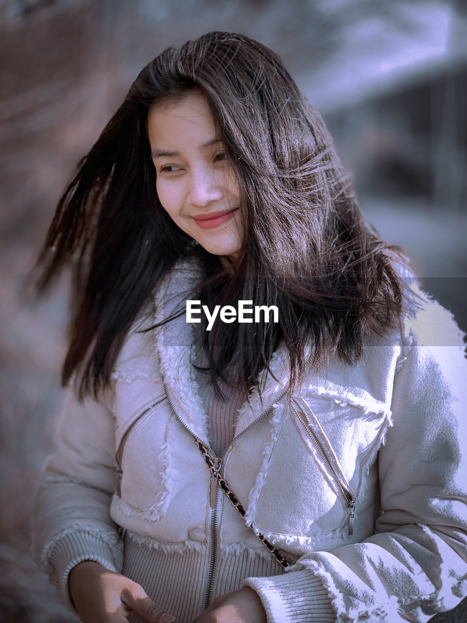 Portrait of beautiful woman sitting outdoors