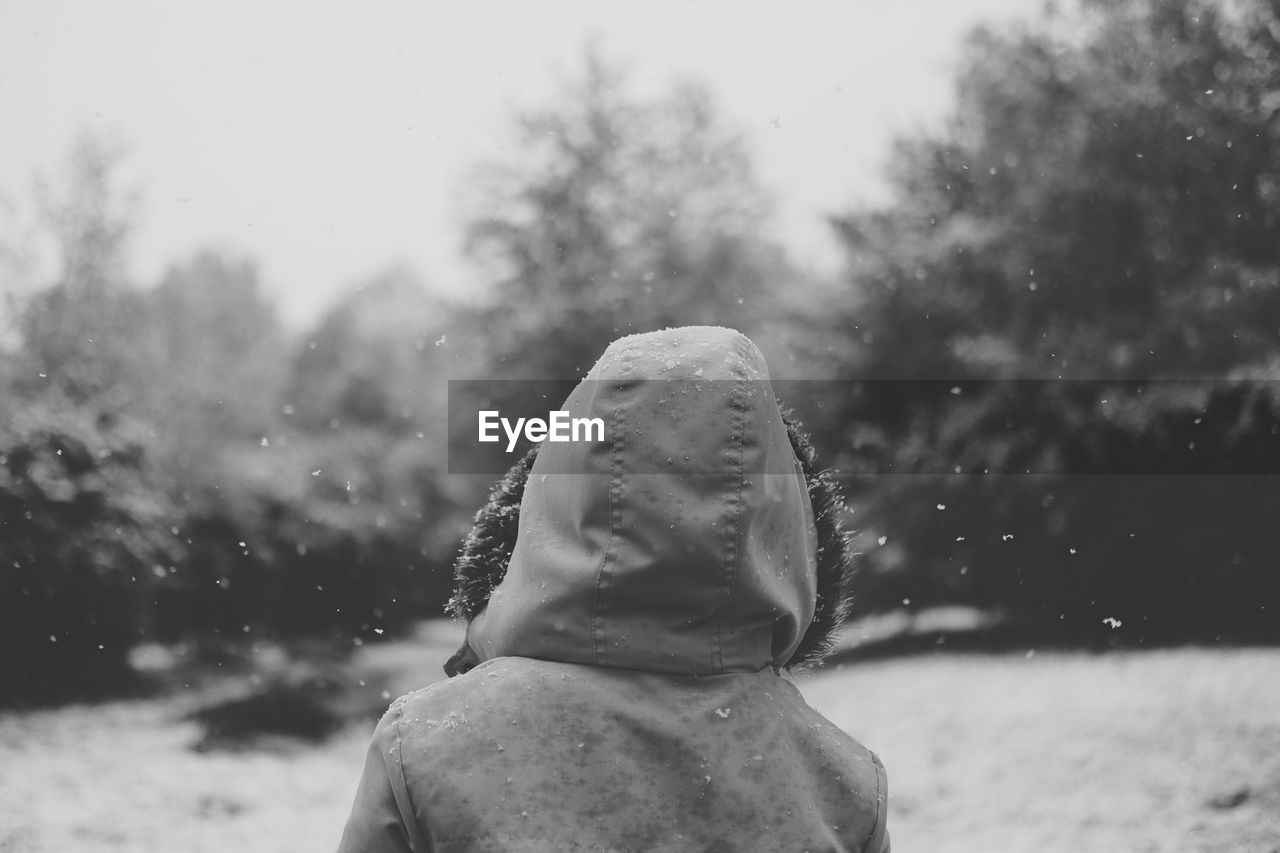 Close-up of person in snow against sky