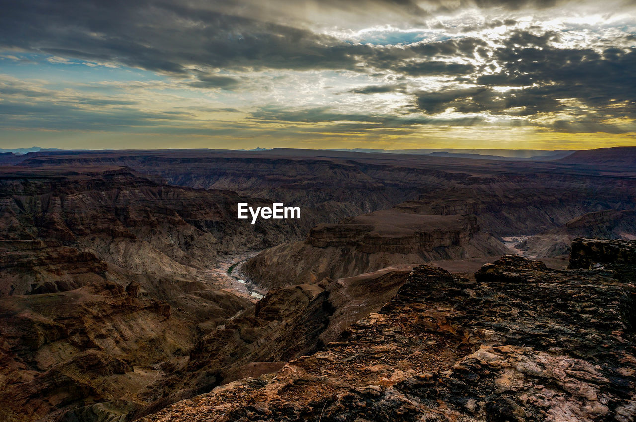 Scenic view of rocky mountains against sky during sunset