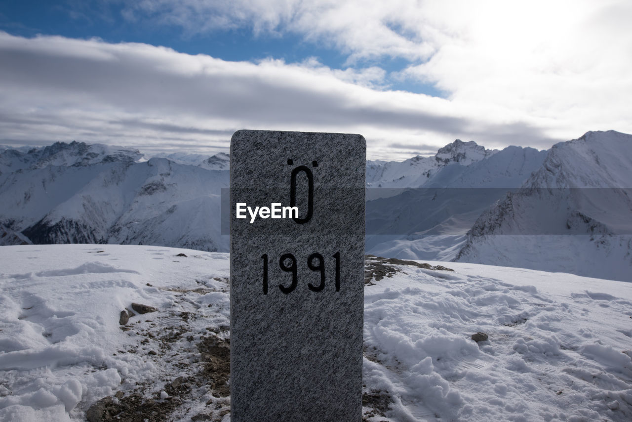 Scenic view of mountain range against cloudy sky