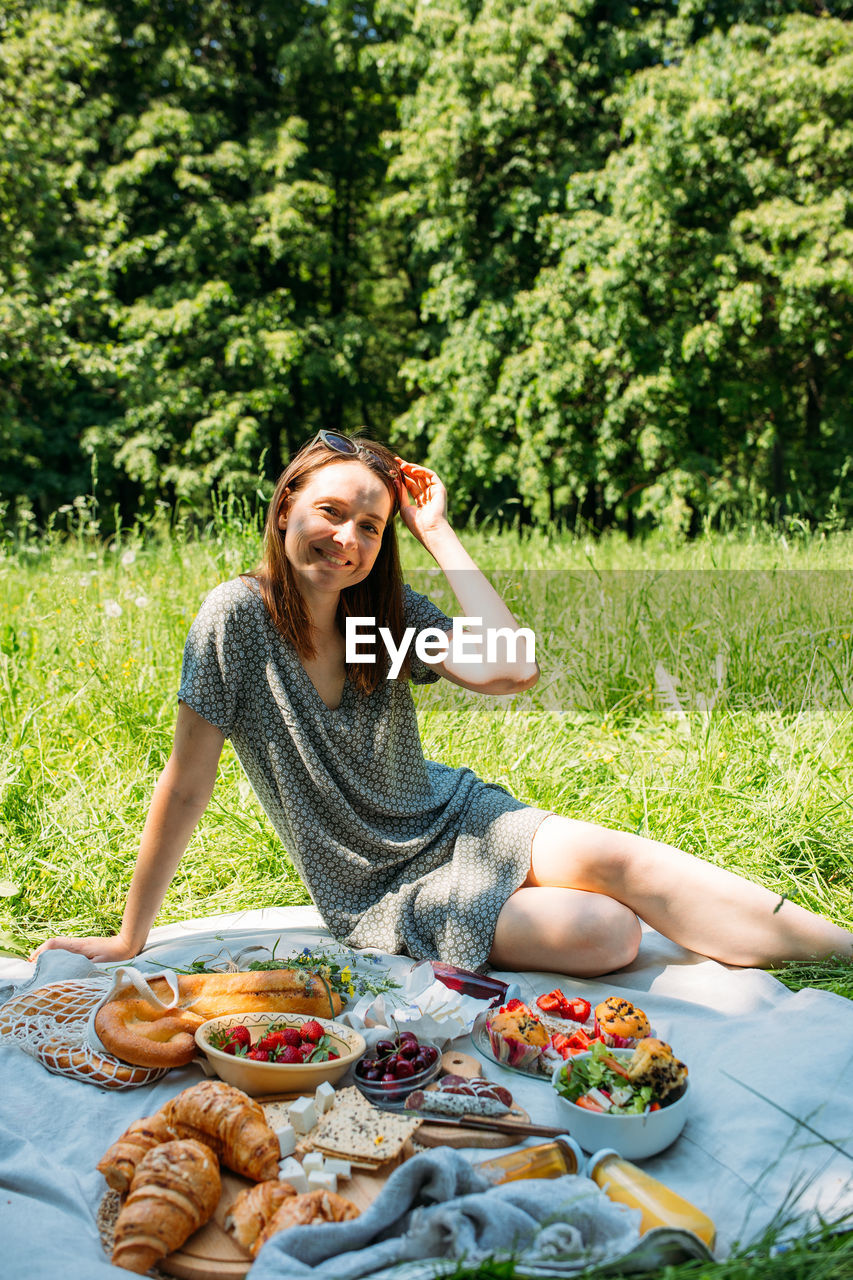 portrait of young woman using mobile phone while sitting on table