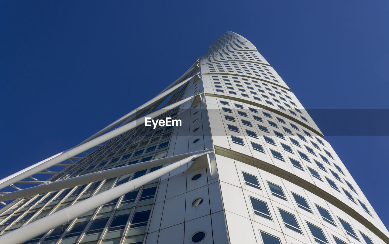 Low angle view of modern building against clear blue sky