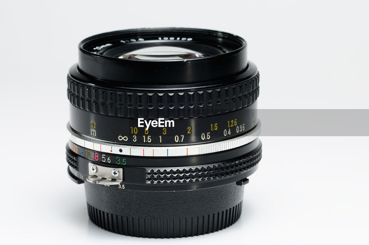 Close-up of camera lens on white background
