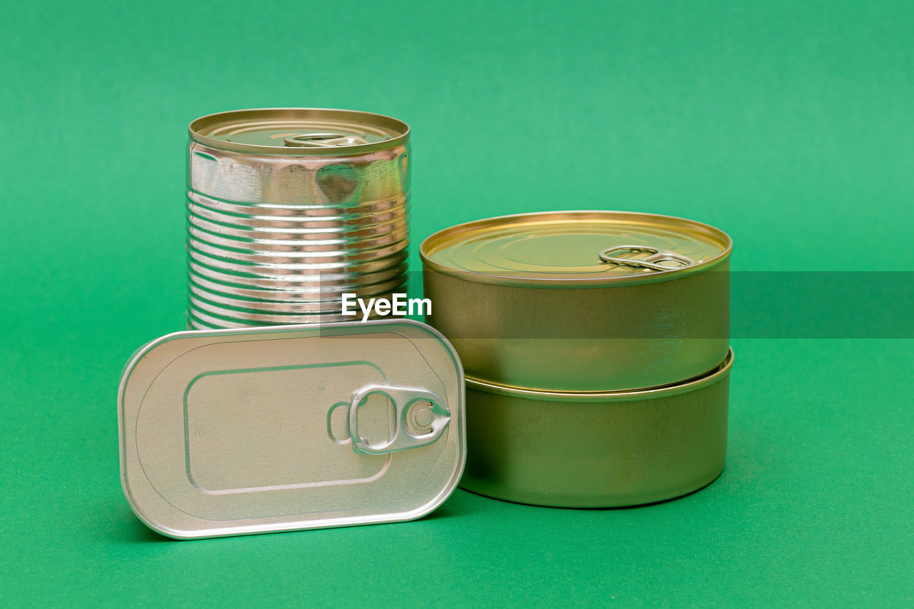 colored background, tin can, can, green background, aluminum, studio shot, metal, green, no people, indoors, recycling, canned food, tin, finance and economy, business finance and industry, finance, container