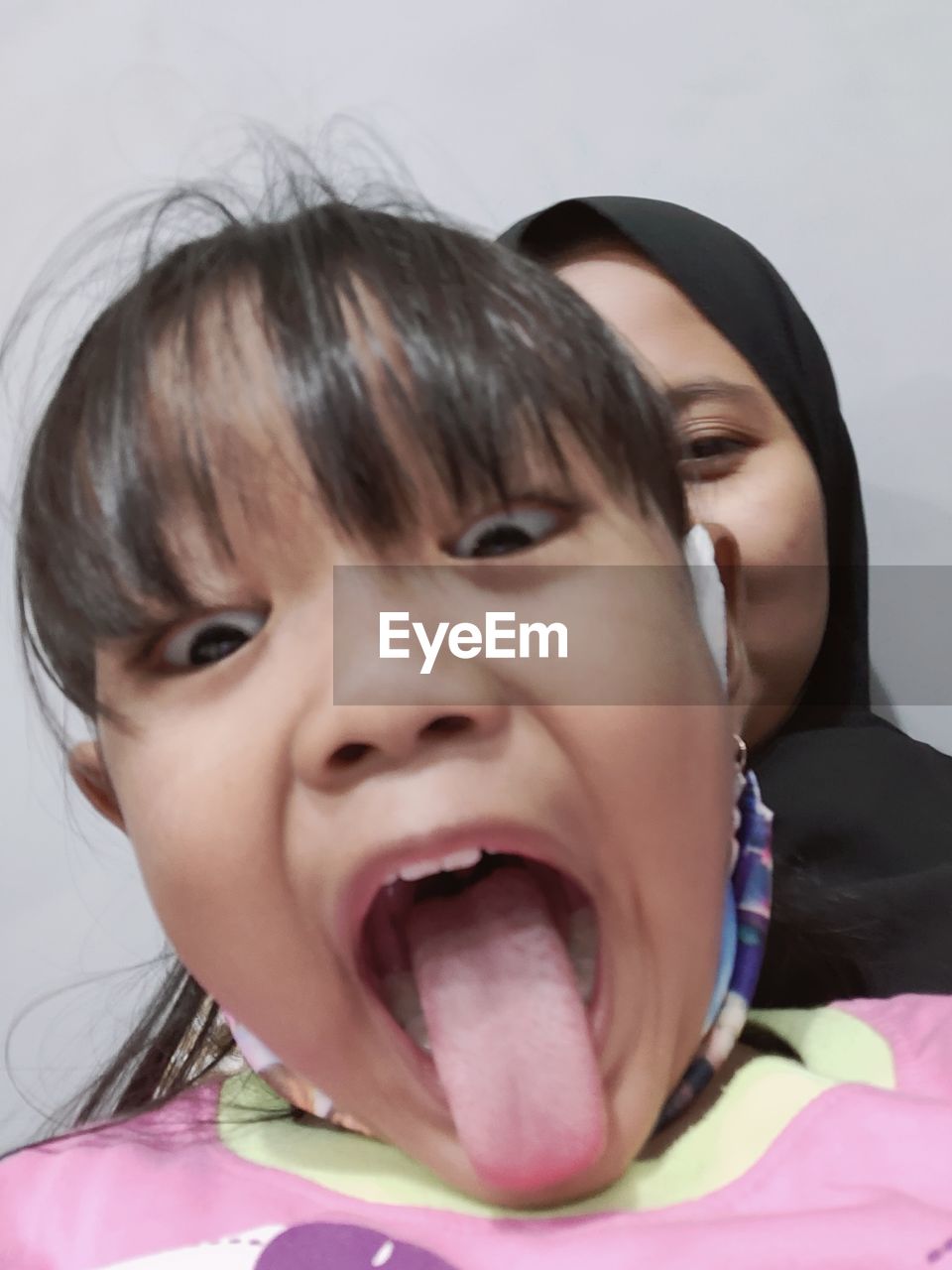 CLOSE-UP PORTRAIT OF CUTE GIRL WITH BABY