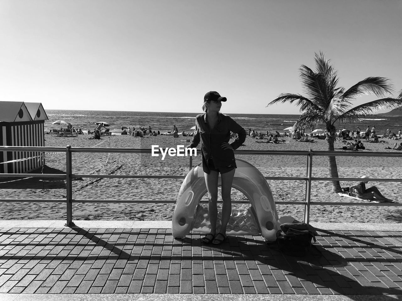 WOMAN SITTING ON SHORE