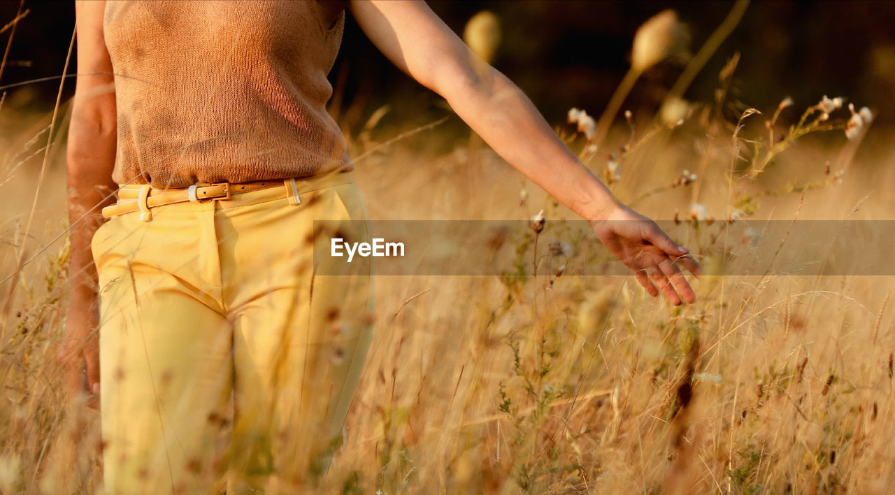 low section of woman standing on field