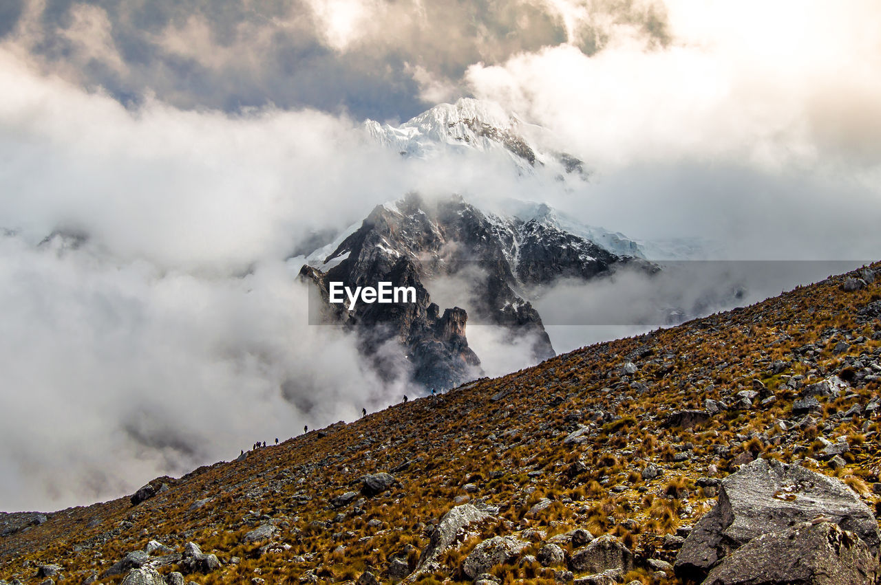 SCENIC VIEW OF CLOUDS OVER MOUNTAINS