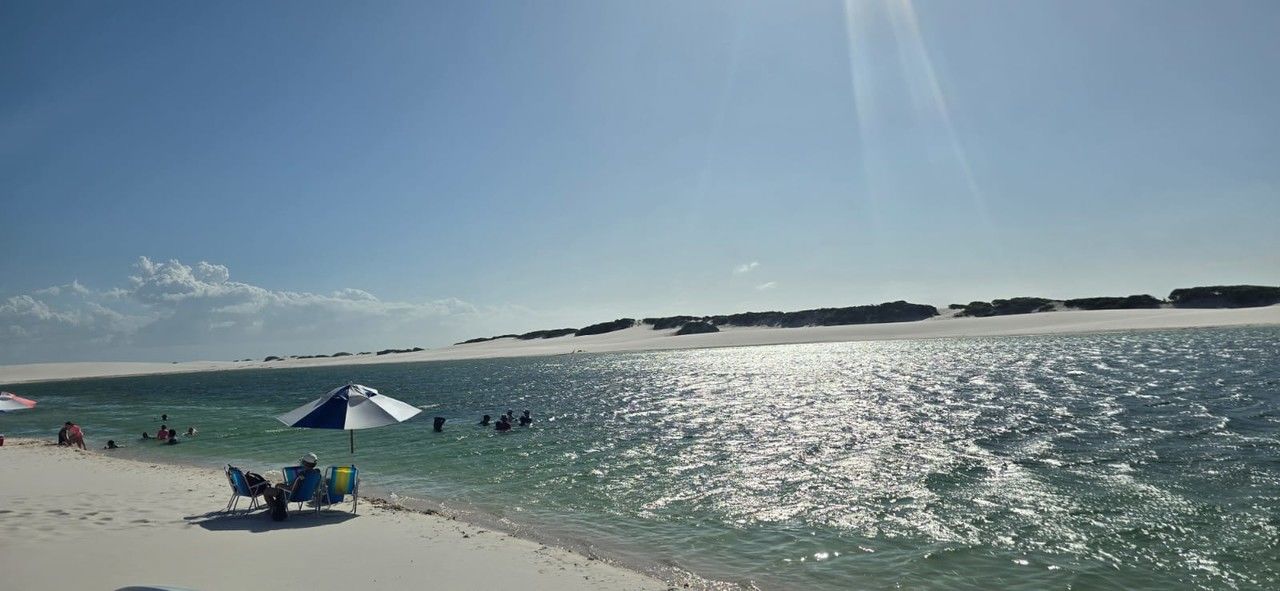 water, sky, sea, ocean, land, beach, nature, beauty in nature, scenics - nature, holiday, sunlight, vacation, trip, shore, travel, coast, horizon, sand, travel destinations, wave, sun, body of water, sunny, tranquility, day, blue, leisure activity, environment, bay, group of people, summer, tourism, clear sky, horizon over water, tranquil scene, outdoors, relaxation, adult, cloud, idyllic, lifestyles, landscape, men, non-urban scene