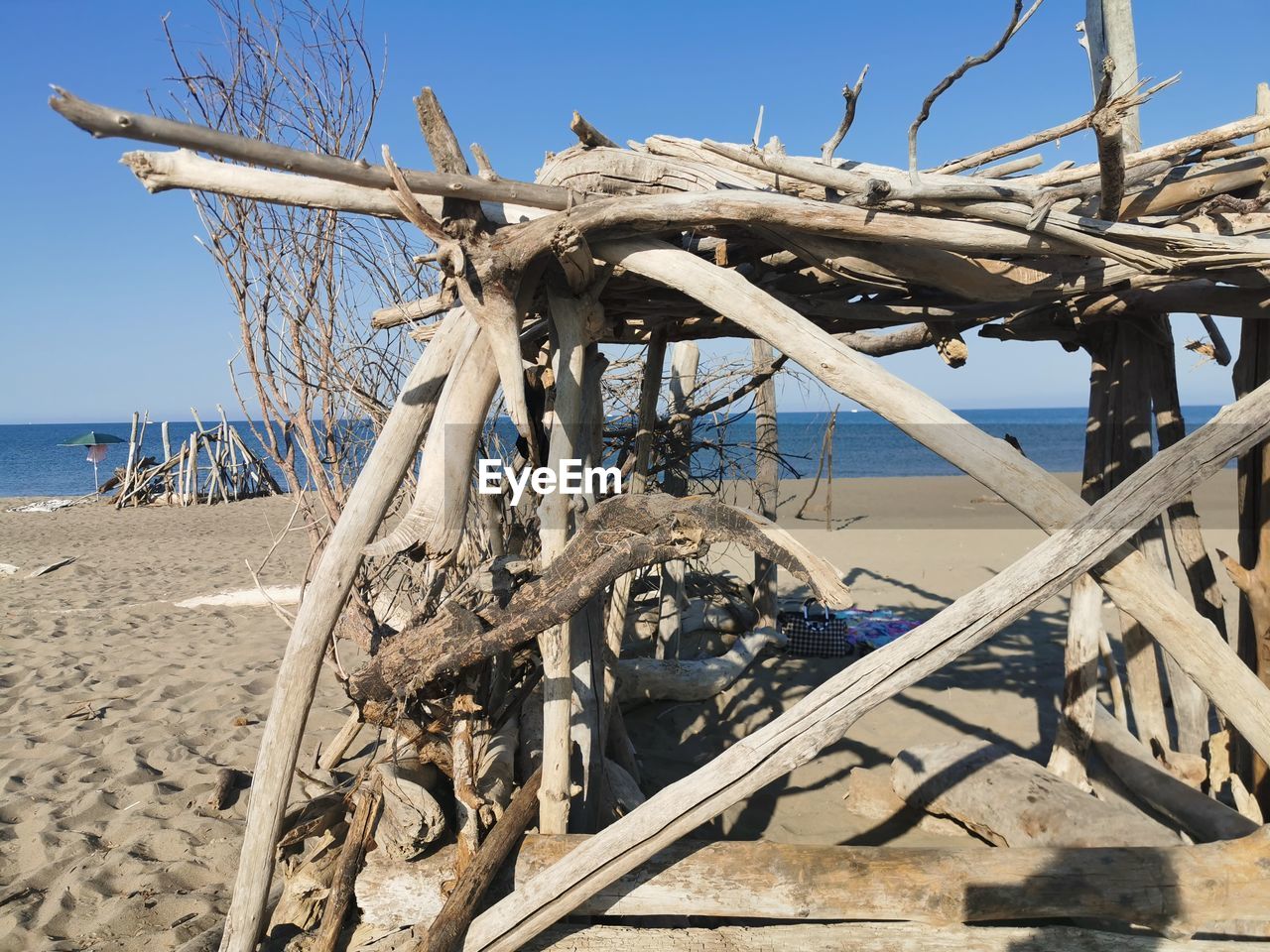 ABANDONED WOODEN STRUCTURE ON BEACH