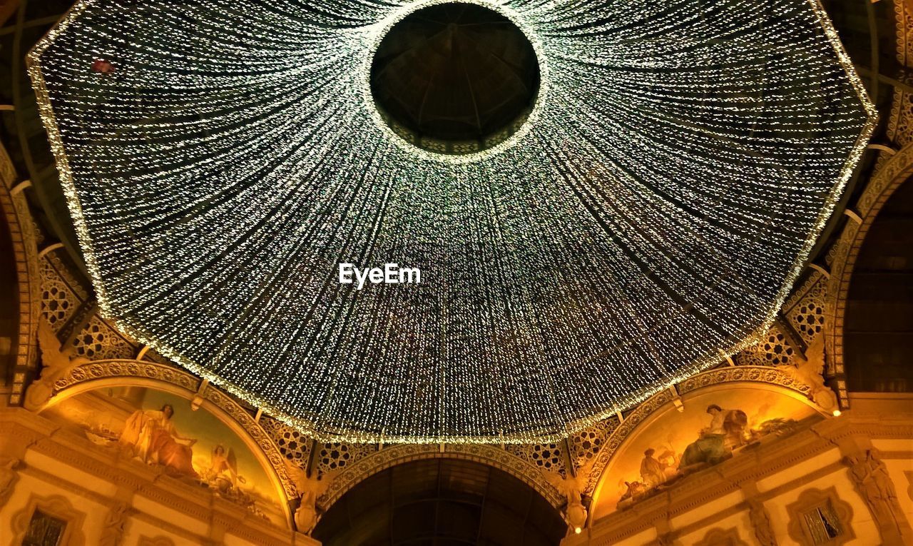 Low angle view of illuminated ceiling of galleria vittorio emanuele 2 in milan