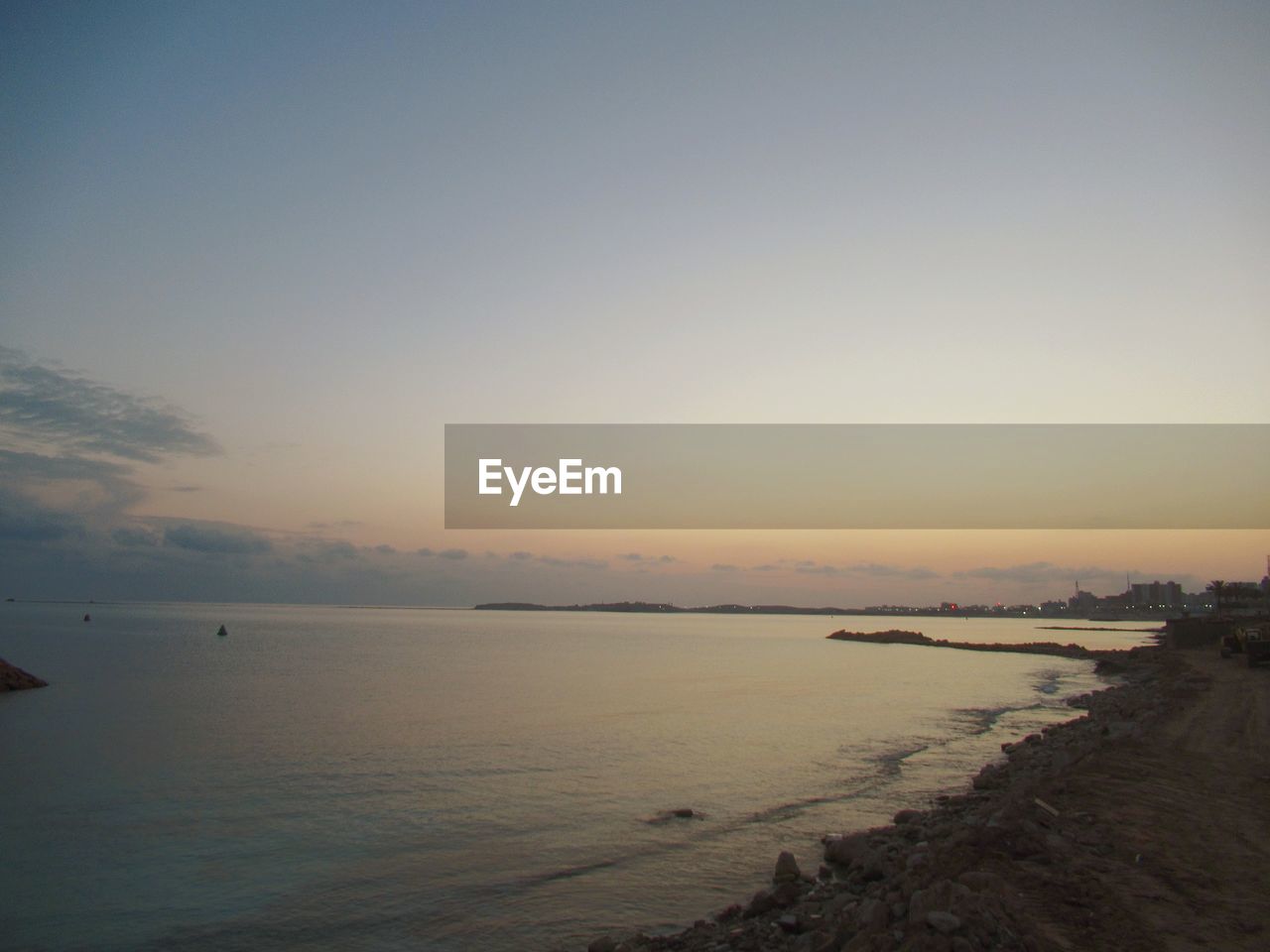 SCENIC VIEW OF BEACH AGAINST SKY DURING SUNSET