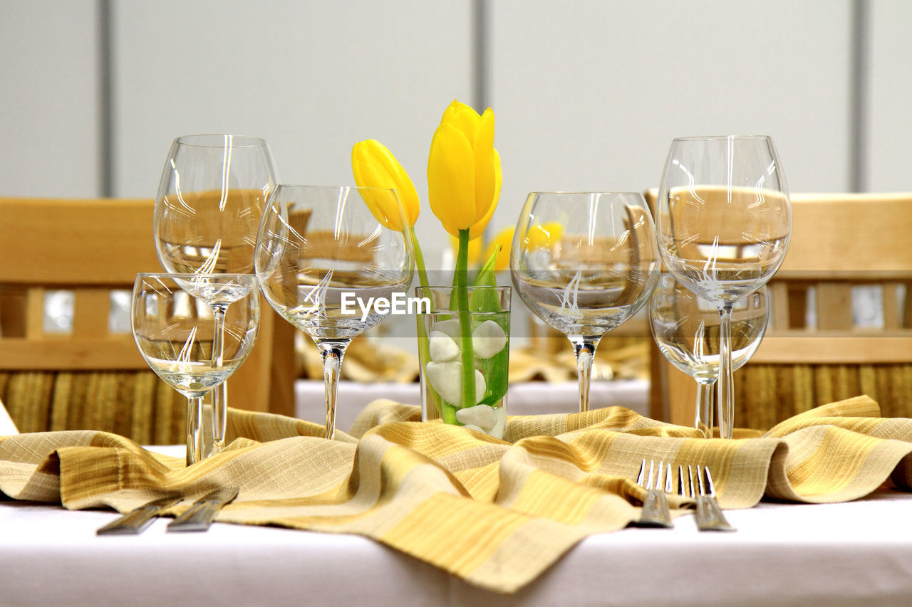 View of wineglasses with flower on table