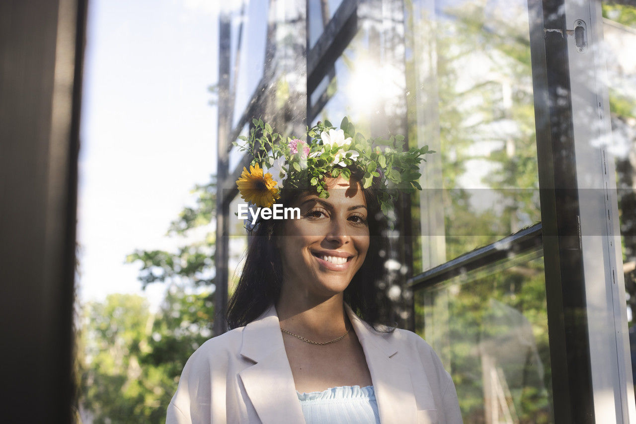 Portrait of smiling woman wearing flower tiara during swedish midsummer celebration