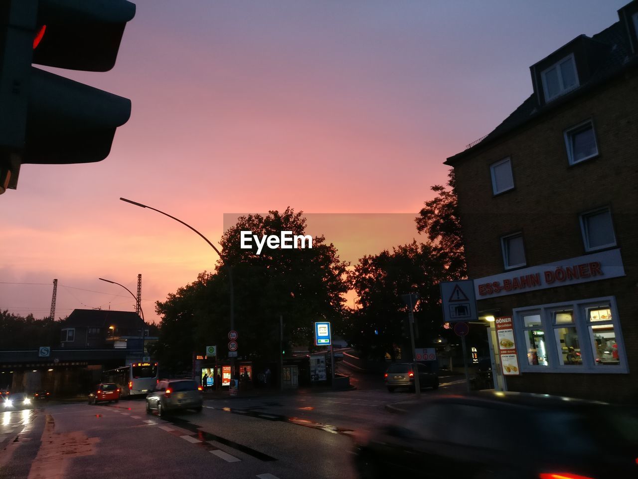 CARS ON ROAD AGAINST SKY DURING SUNSET