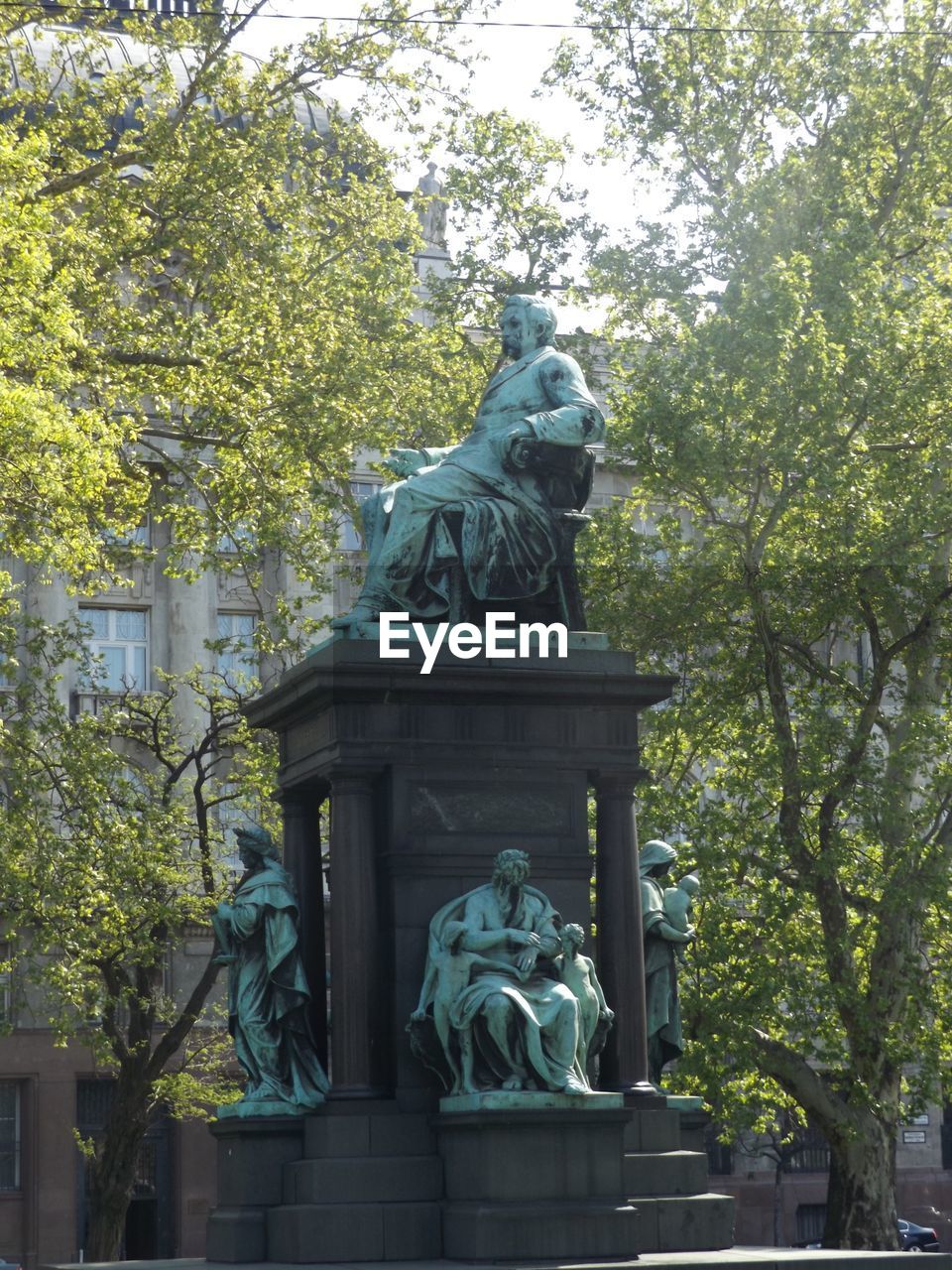 Low angle view of statues against trees