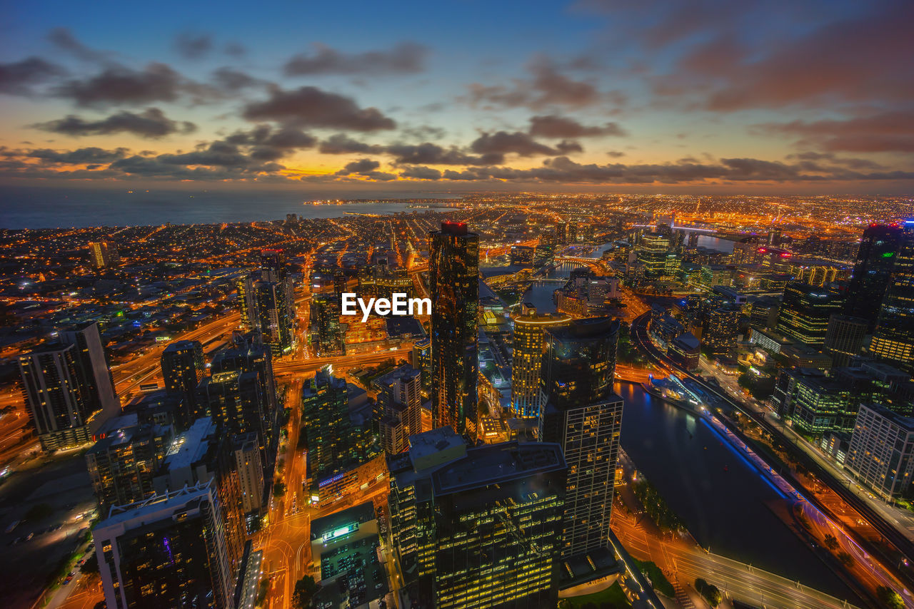 High angle view of city lit up at night