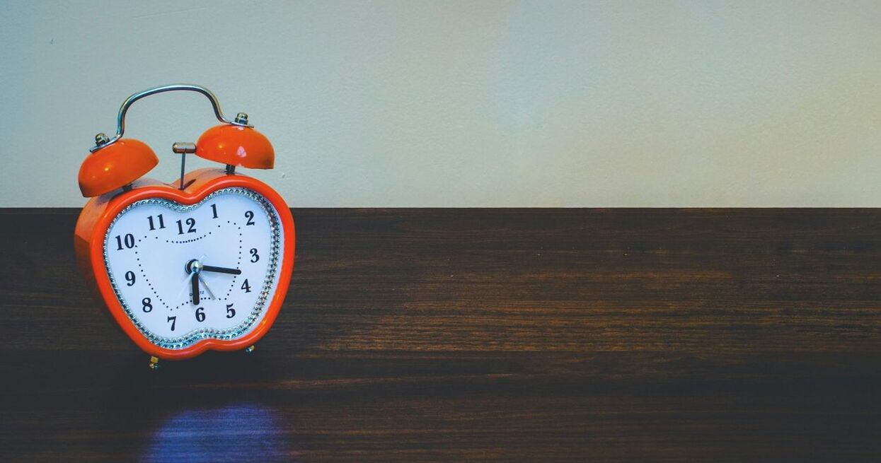 CLOSE-UP OF CLOCK ON WALL