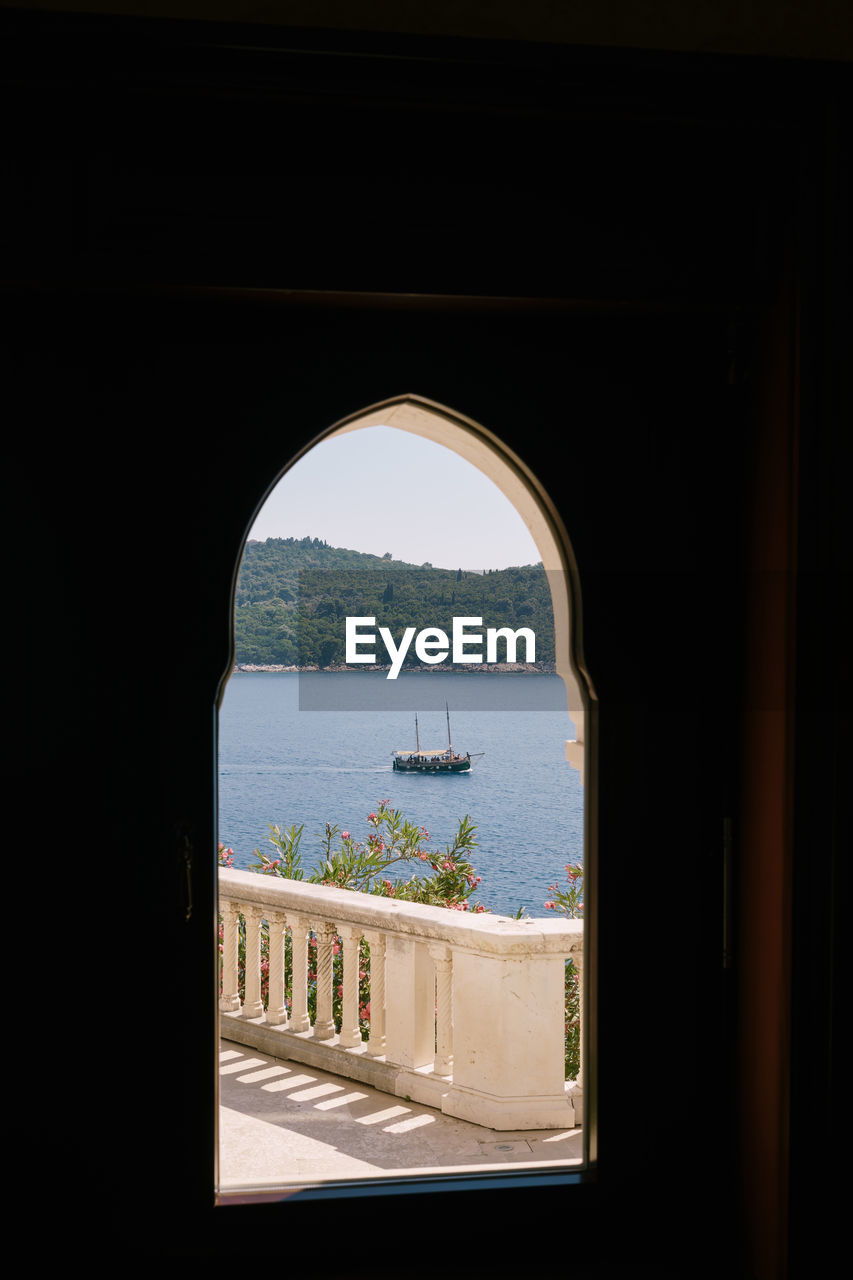 VIEW OF SEA SEEN THROUGH WINDOW