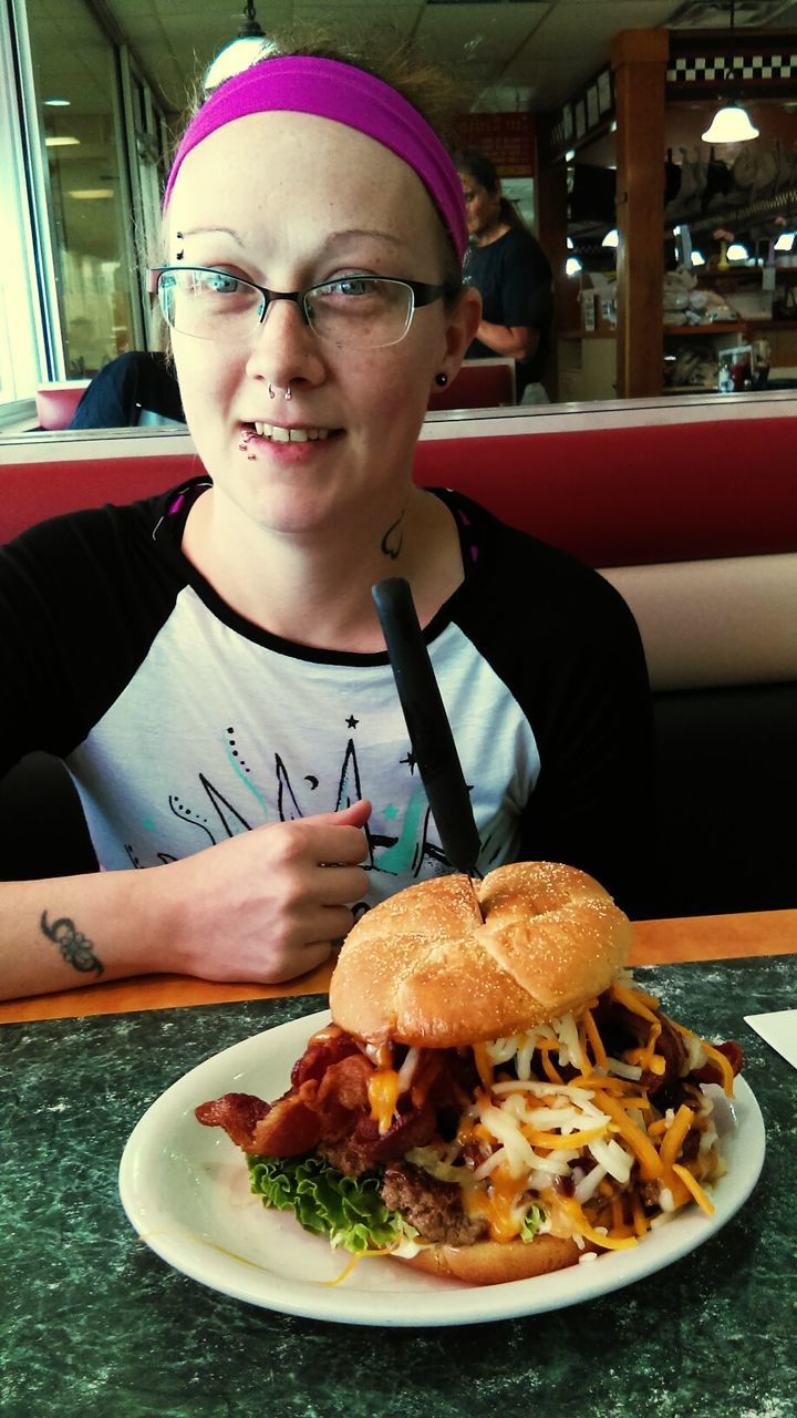 HIGH ANGLE VIEW OF YOUNG WOMAN EATING FOOD