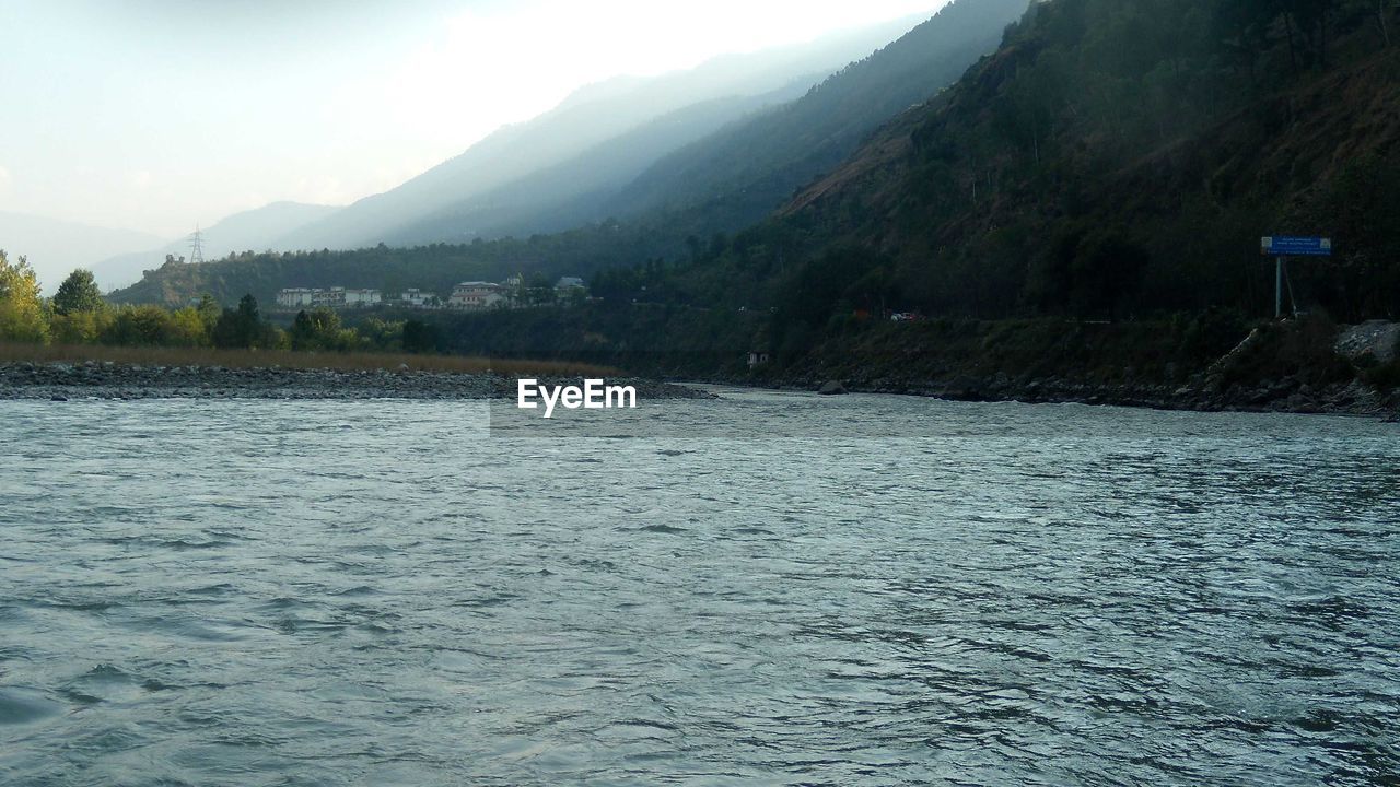 SCENIC VIEW OF RIVER AGAINST MOUNTAINS